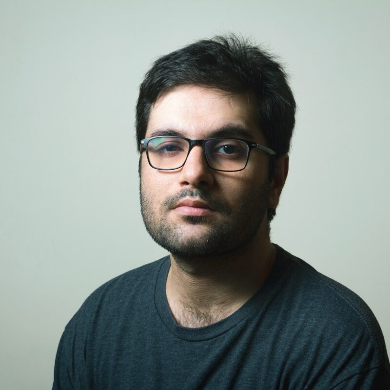 man in black crew neck shirt wearing black framed eyeglasses